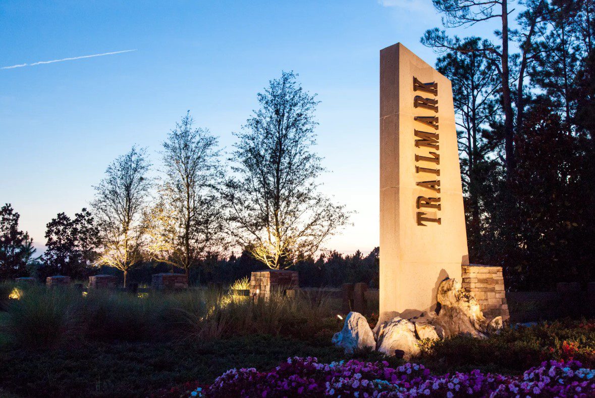 Trailmark neighborhood entrance monument sign illuminated at dusk in St. Johns County, Florida