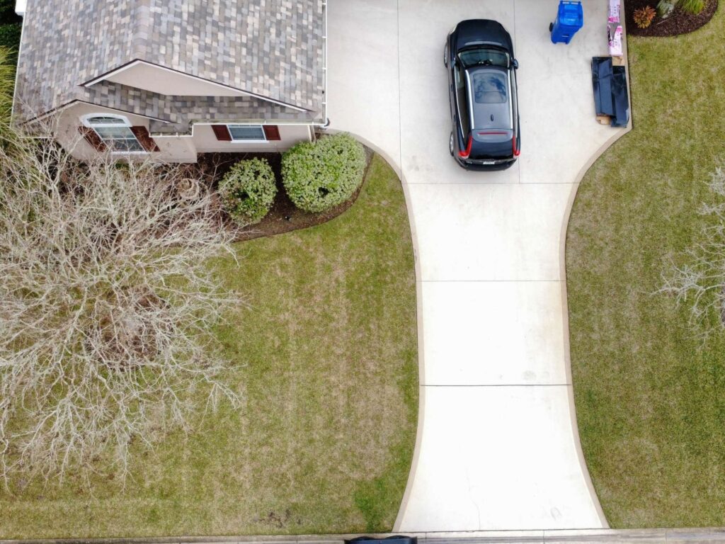 Drone view of residential front yard lawn and driveway in St. Augustine