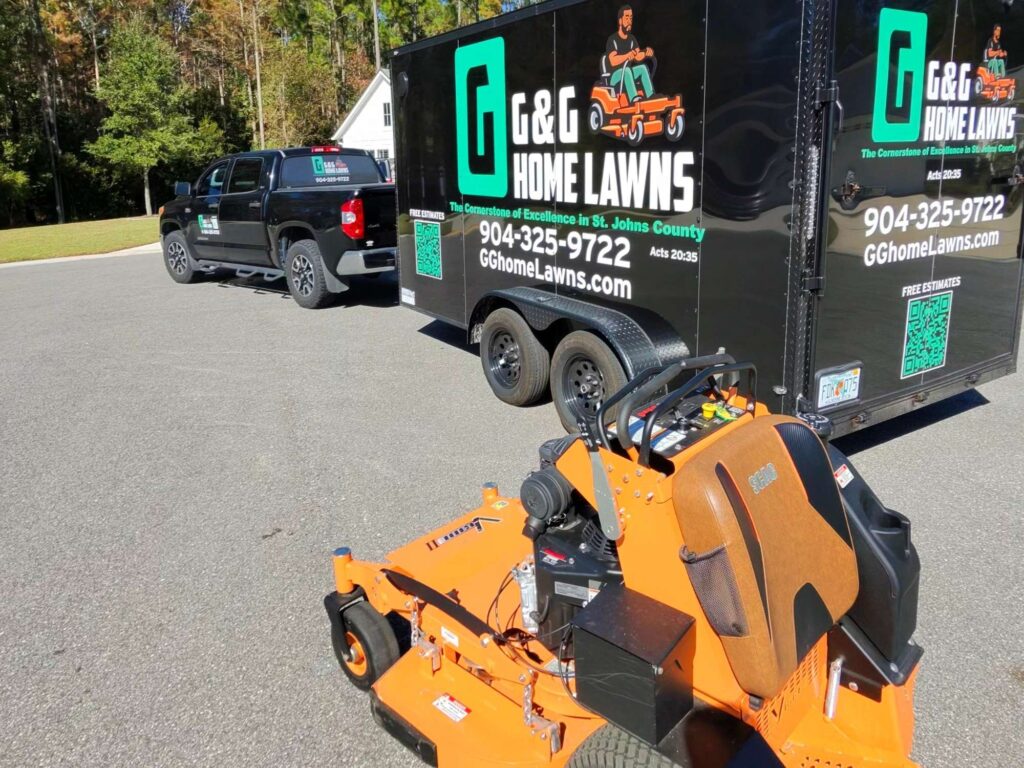 G&G Home Lawns truck, trailer, and commercial mower parked in St. Augustine neighborhood